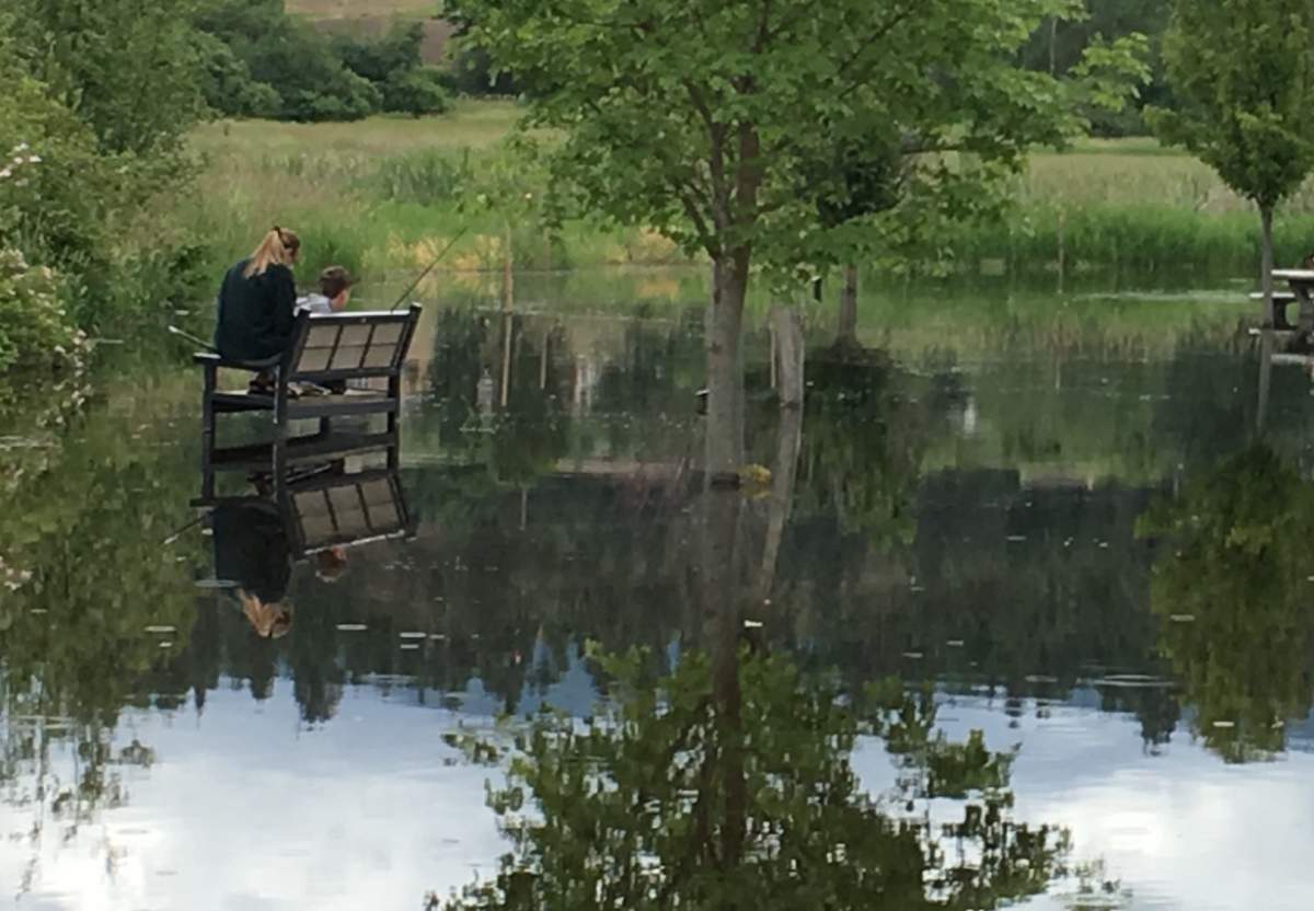 An unusual sight as a young Okanagan resident fishes while sitting on a bench behind the Capital News Centre in Kelowna.