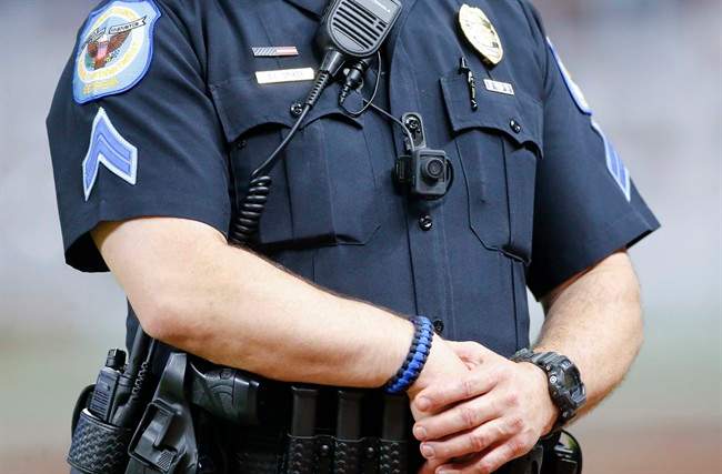 A police officer wears a body camera as he works an off-duty security detail at at an Atlanta Braves baseball game in Atlanta, May 24, 2017.