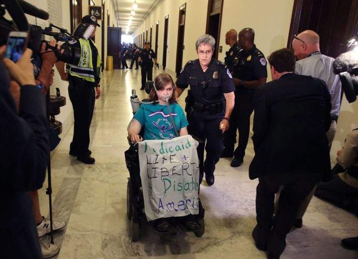U.S. Capitol Police remove a protester from in front of the office of Senate Majority Leader Mitch McConnell.