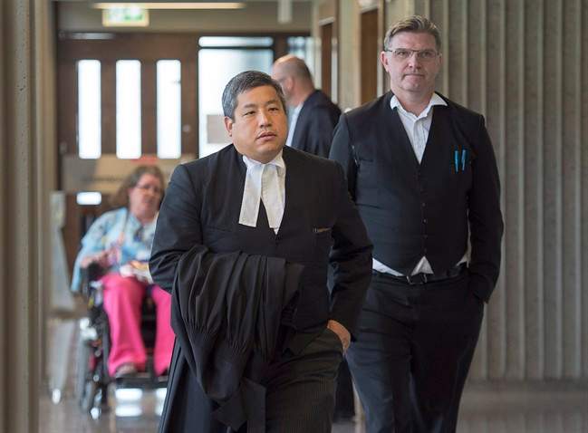 William Sandeson’s defence team, Brad Sarson (right) and Eugene Tan (foreground) attend Nova Scotia Supreme Court in Halifax on June 16, 2017. (Andrew Vaughan/Canadian Press)