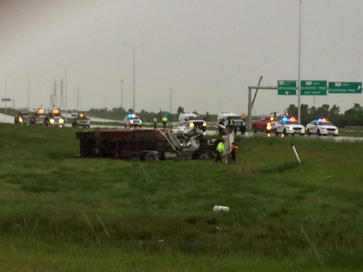 Police have surrounded a semi-trailer flipped on its side.