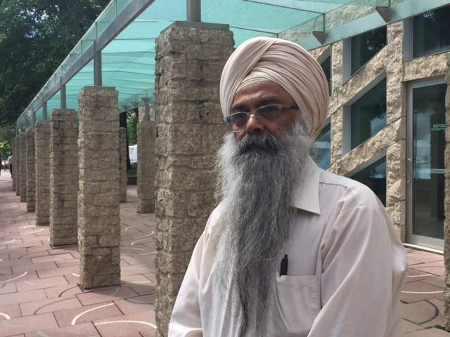 Headway School principal J.S. Sindhu stands outside city hall.