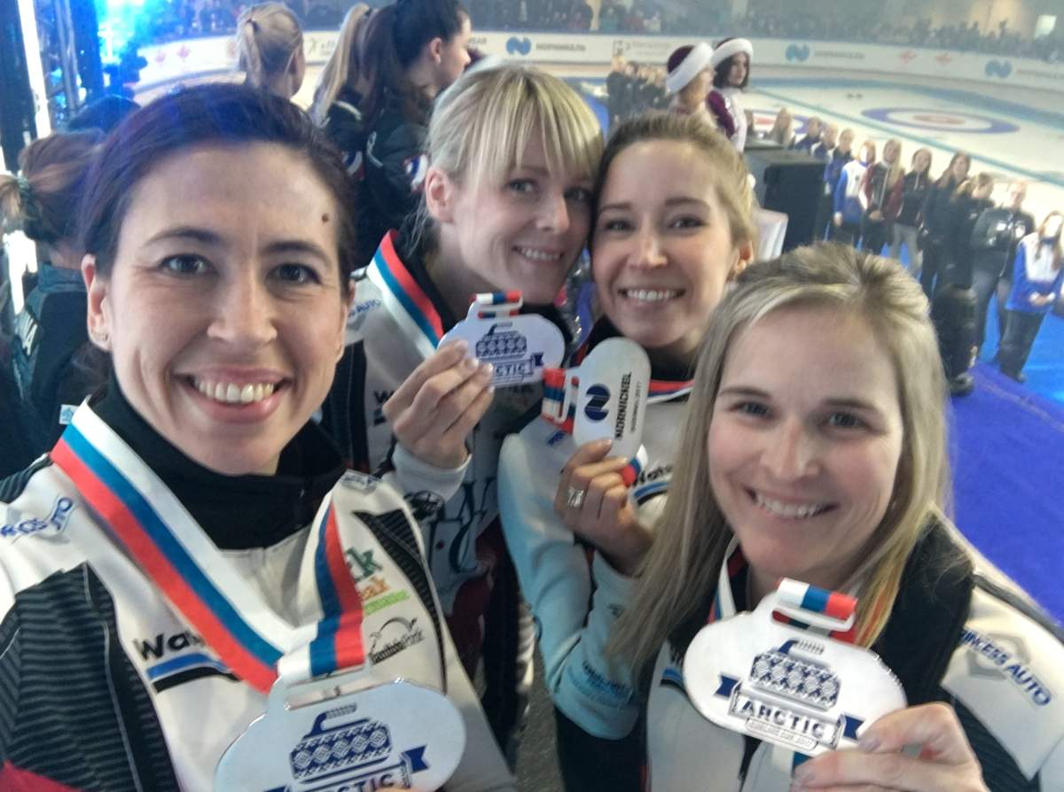 Posing on the podium after receiving their silver medals.