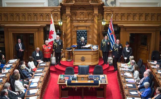 FILE PHOTO: British Columbia Premier Christy Clark, left, and NDP leader John Horgan, right, look on as B.C. Lieutenant Governor Judith Guichon gives the Speech from Throne in Victoria, Thursday, June 22, 2017. 
