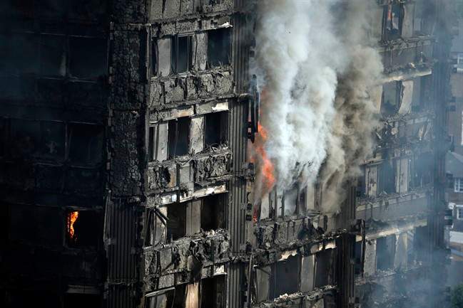 Parts of the building still burn hours after a deadly blaze at a high rise apartment block in London, Wednesday, June 14, 2017. Fire swept through a high-rise apartment building in west London early Wednesday, killing an unknown number of people with around 50 people being taken to hospital.