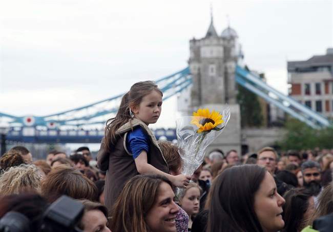 People attend a vigil for victims of Saturday's attack in London Bridge, at Potter's Field Park in London, Monday, June 5, 2017. Police arrested several people and are widening their investigation after a series of attacks described as terrorism killed several people and injured more than 40 others in the heart of London on Saturday. 