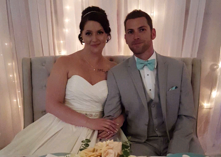 Melissa and Dan Hofman sit on the love seat they bought on Facebook at their wedding on June 17, 2017.