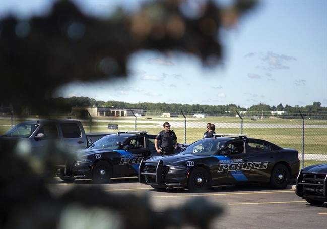 Burton Police Officers gather at Bishop International Airport, Wednesday morning, June 21, 2017, in Flint, Mich.