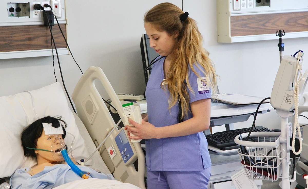 Nursing Student Rianna Longo (BScN Class of 2018) cares for ‘Joanne’, a mannequin programmed to have breast cancer and other ailments as part of the new 16-bed simulation suites in the Arthur Labatt Family School of Nursing on June 6, 2017.