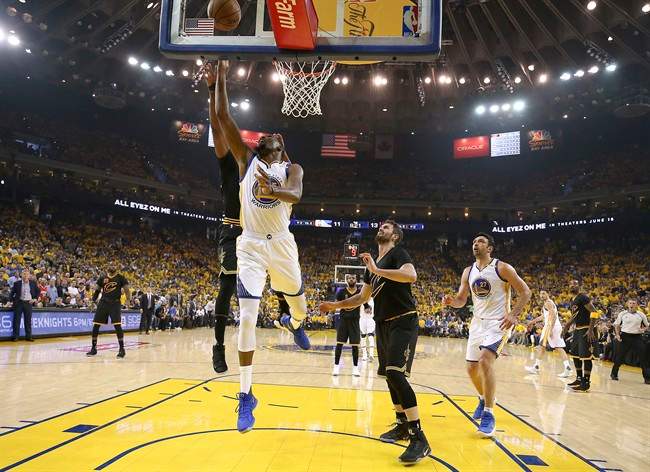 Golden State Warriors forward Kevin Durant shoots against the Cleveland Cavaliers during the first half of Game 2 of basketball's NBA Finals in Oakland, Calif., Sunday, June 4, 2017.