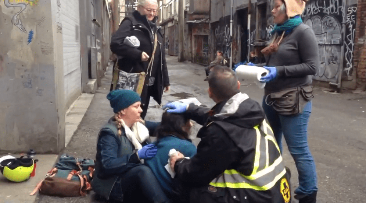 Civilian volunteers in the DTES attend to another overdose.