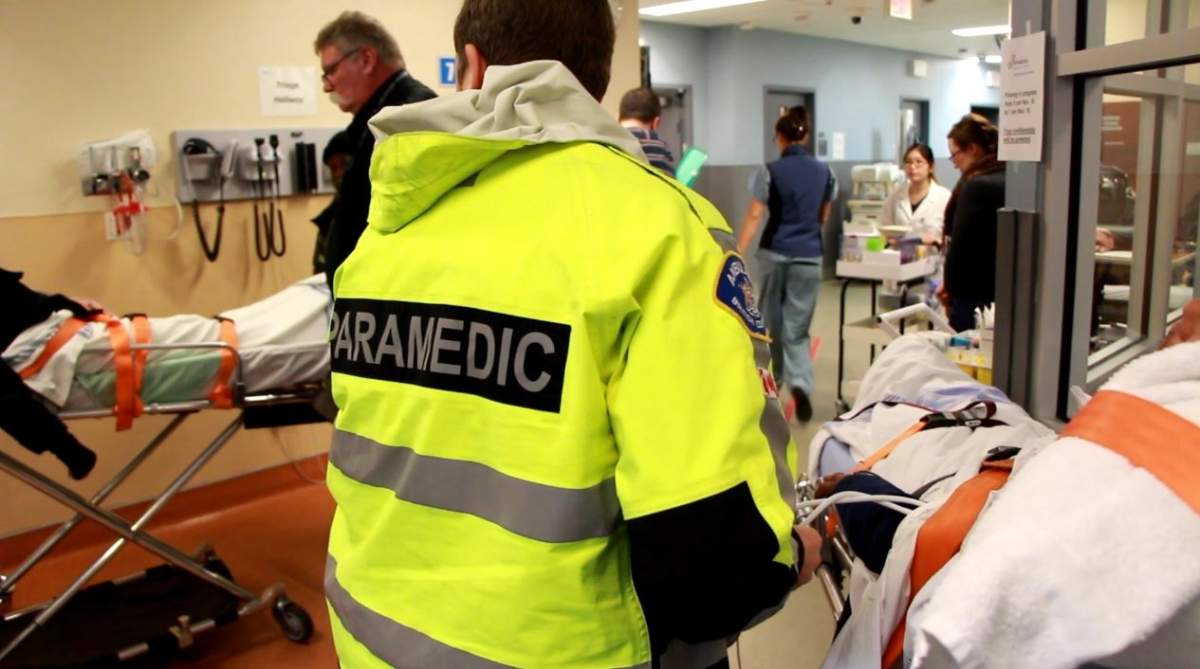 A paramedic tends to an overdose patient in the St. Paul’s Hospital ambulance bay.
