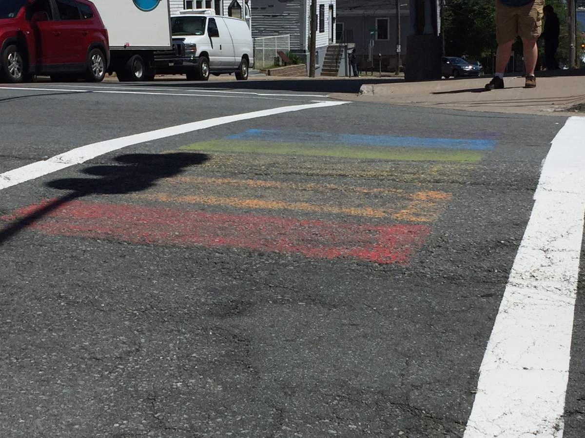 File - The crosswalks at the intersection of Barrington Street and Cornwallis Street are decorated with a rainbow pattern.