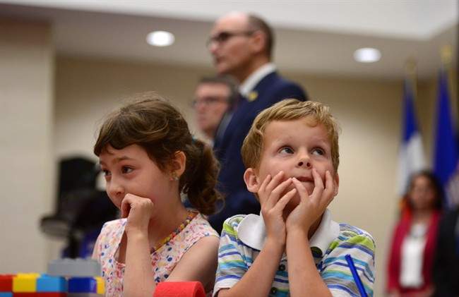 Bryson Boyce-Pettes, 5, right, and Eleonore Alamillo-Laberge, 6, take part in a press conference as Social Development Minister Jean-Yves Duclos and P.E.I. Minister of Education, Doug Currie, speak as federal-provincial and territorial ministers responsible for "Early Learning and Child Care" meet in Ottawa on Monday, June 12, 2017.