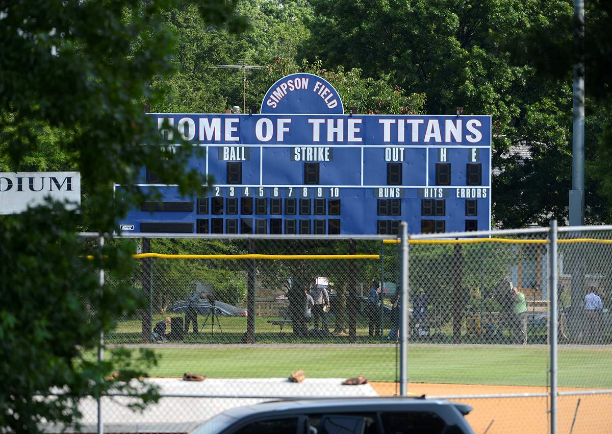 Investigators under a scoreboard search for clues at the scene where shots were fired during a congressional baseball practice, wounding House Majority Whip Steve Scalise (R-LA), in Alexandria, Virginia, U.S., June 14, 2017.