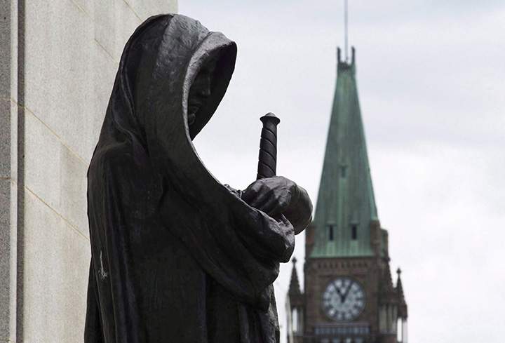 The Peace tower on Parliament Hill is seen behind the justice statue outside the Supreme Court of Canada in Ottawa, Monday June 6, 2016. 