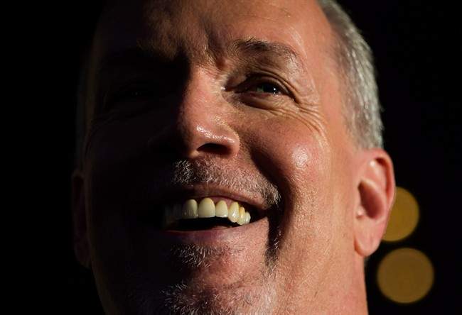 British Columbia Premier-designate, NDP Leader John Horgan smiles while speaking outside Government House after meeting with Lt-Gov. Judith Guichon in Victoria, B.C., on Thursday, June 29, 2017. 