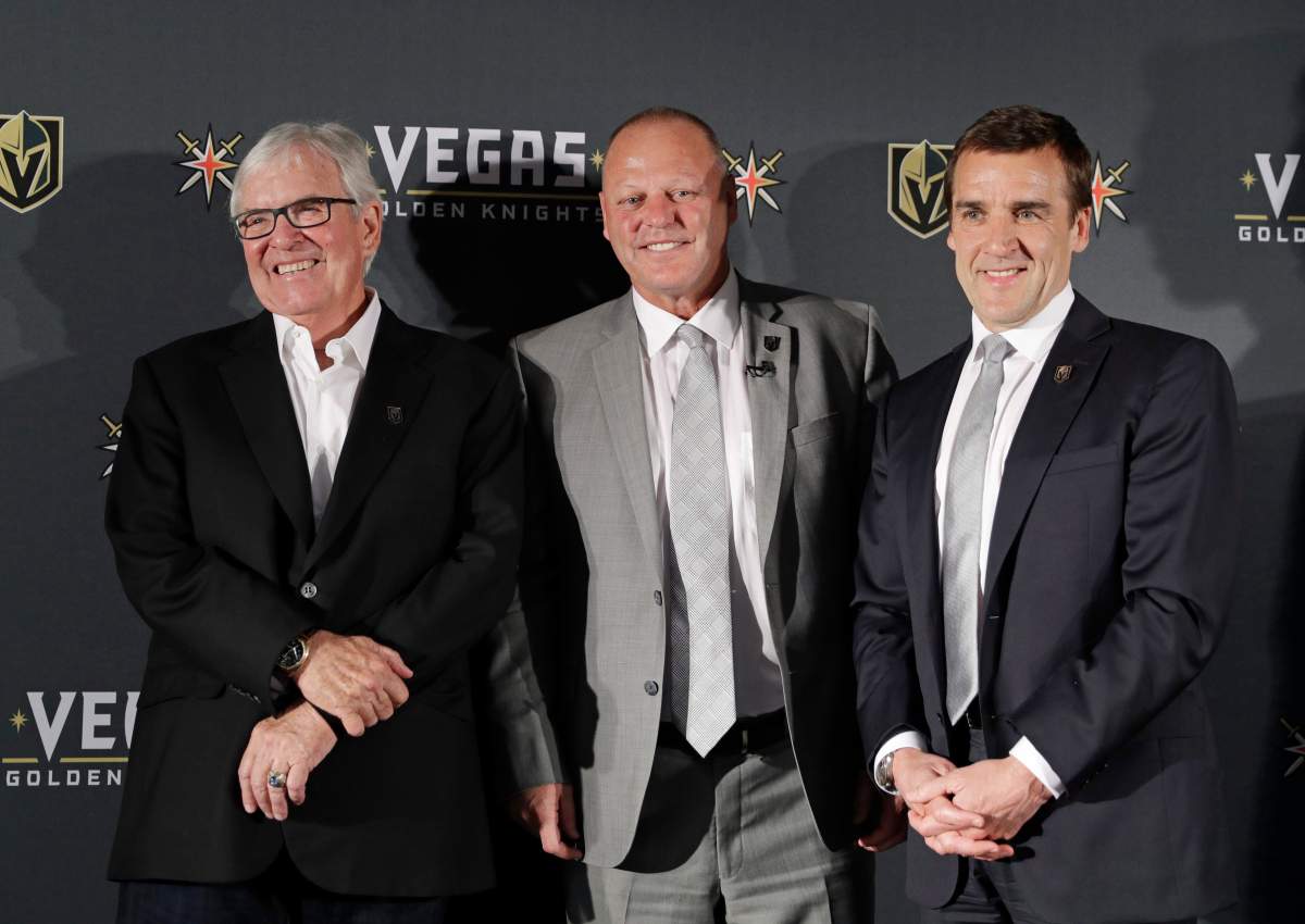 FILE – In this April 13, 2017, file photo, Vegas Golden Knights coach Gerard Gallant is flanked by Bill Foley, left, owner of the Vegas Golden Knights, and George McPhee, Vegas Golden Knights general manager, in Las Vegas. Vegas Golden Knights general manager George McPhee certainly wouldn’t mind some Lady Luck to rub off on his NHL expansion franchise when it comes to how the balls drop in the league’s draft lottery on Saturday.