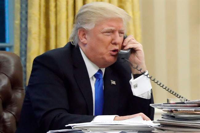 In this Jan. 28, 2017 file photo, U.S. President Donald Trump speaks on the phone in the Oval Office of the White House in Washington. 