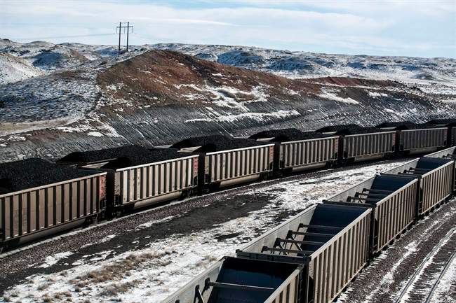 FILE – In this Jan. 9, 2014, file photo, rail cars are filled with coal and sprayed with a topper agent to suppress dust at Cloud Peak Energy’s Antelope Mine north of Douglas, Wyo.