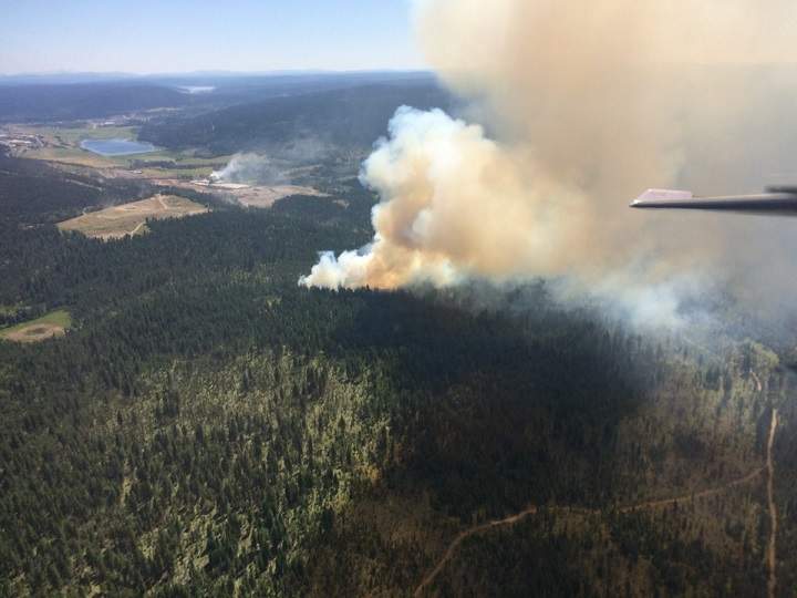 Air and ground crews are battling a forest fire west of 100 Mile House.