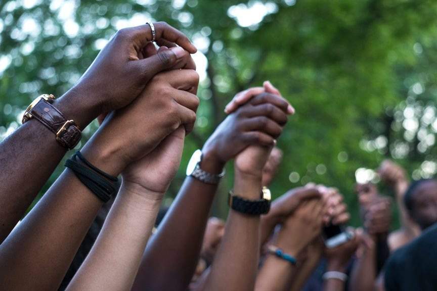 Demonstrators hold hands.