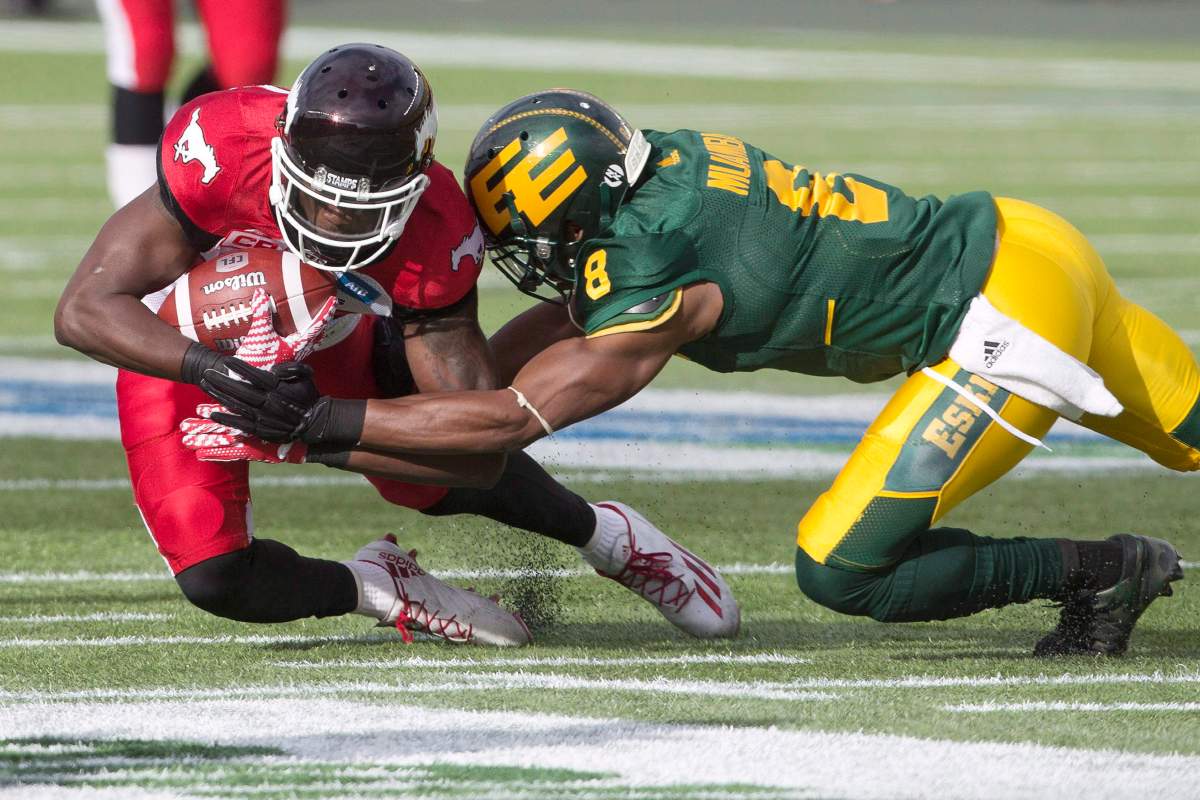 Calgary Stampeders DaVaris Daniels (89) is tackled by Edmonton Eskimos Cauchy Muamba (8) during first half CFL action in Edmonton, Alta., on Saturday September 10, 2016. 
