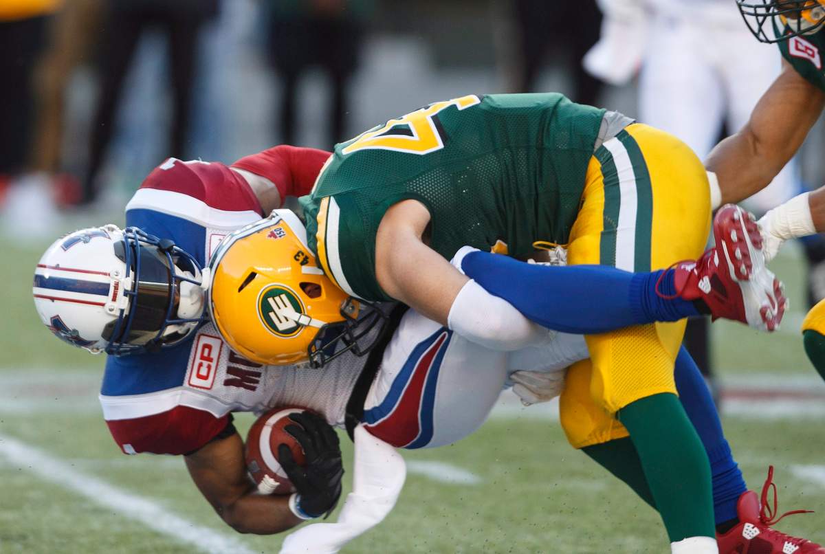 Montreal Alouettes’ Tiquan Underwood (1) is tackled by Edmonton Eskimos’ Neil King (43) during first half CFL action in Edmonton on Friday, June 30, 2017.