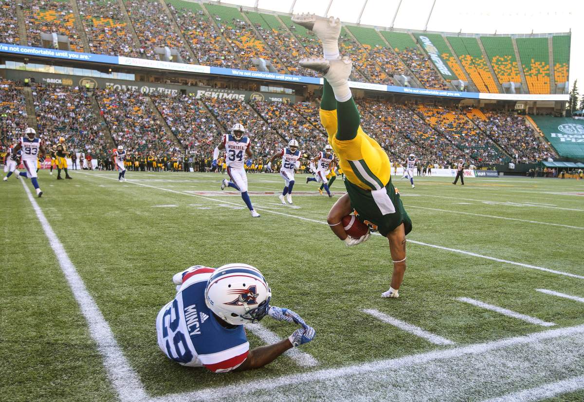 Montreal Alouettes’ Jonathon Mincy (29) upends Edmonton Eskimos’ Calvin McCarty (31) during first half CFL action in Edmonton on Friday, June 30, 2017.