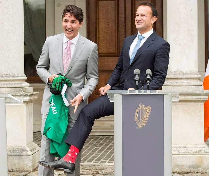 Prime Minister Justin Trudeau laughs as Irish Taoiseach Leo Varadkar shows him his Maple Leaf socks during their press conference at Farmleigh House Tuesday in Dublin.