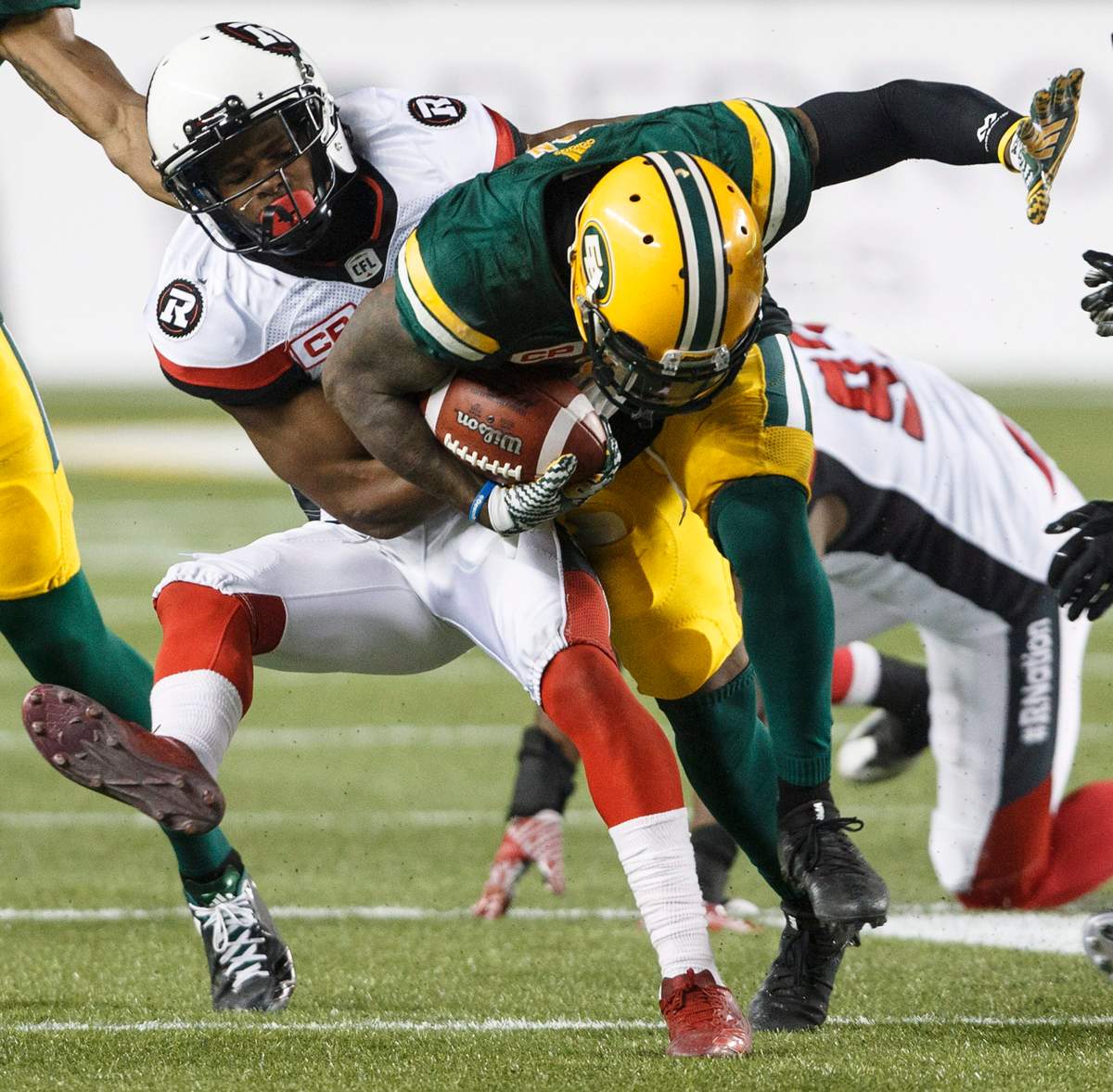 Ottawa Redblacks’ Corey Tindal (28) tackles Edmonton Eskimos Travon Van (5) during second half CFL action in Edmonton, Alta., on Friday July 14, 2017. THE CANADIAN PRESS/Jason Franson.