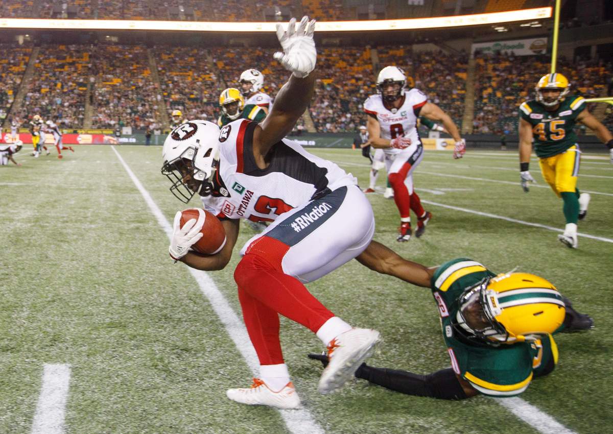 Ottawa Redblacks’ Brett Maher (13) is taken down by Edmonton Eskimos’ Kenny Ladler (37) during second half CFL action in Edmonton, Alta., on Friday July 14, 2017. THE CANADIAN PRESS/ Jason Franson.