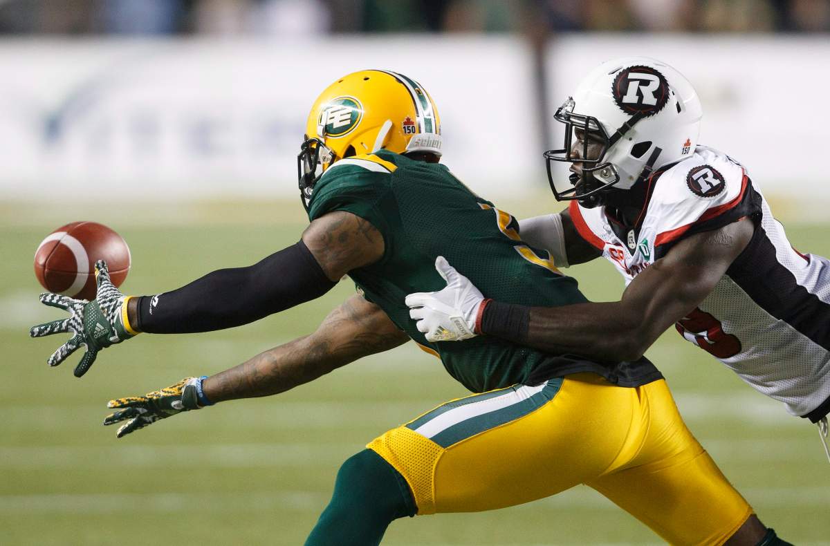 Ottawa Redblacks' William Powell (29) gives chase as Edmonton Eskimos' Travon Van (5) misses the catchduring second half CFL action in Edmonton, Alta., on Friday July 14, 2017.
