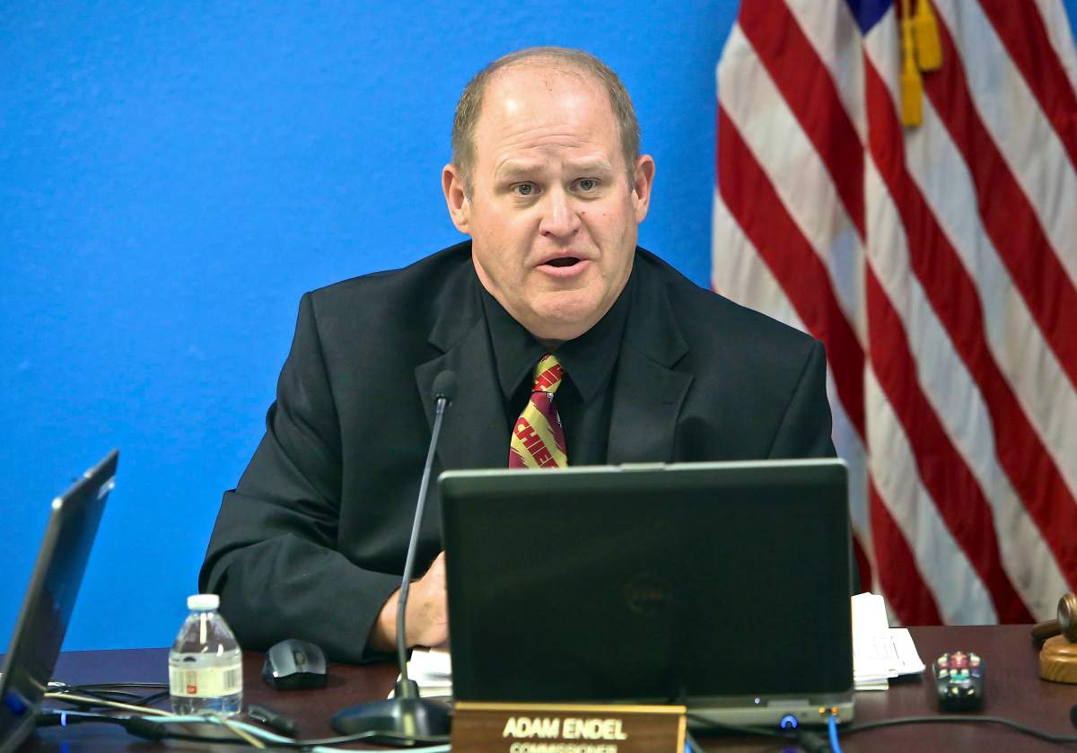 Nevada parole commissioner Adam Endel wears a Kansas City Chiefs tie while listening to testimony from former NFL football star O.J. Simpson, who is appearing by video conference, during Simpson’s parole hearing in Carson City, Nev., Thursday, July 20, 2017.