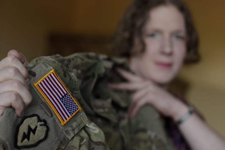 In this July 29, 2017 photo transgender U.S. army captain  Jennifer Sims lifts her uniform during an interview with The Associated Press in Beratzhausen near Regensburg, Germany.  