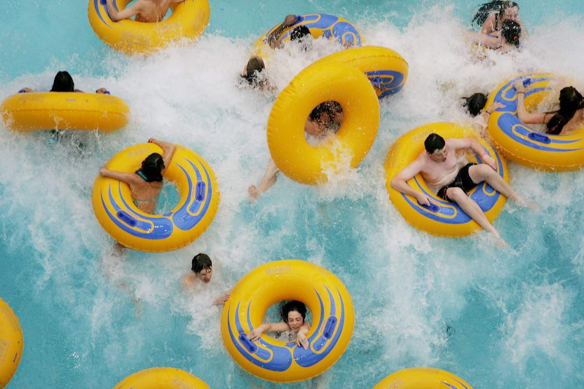 People riding tubes get splashed and overturned by waves in the World Waterpark's wave pool in West Edmonton Mall in Edmonton, Alberta on Thursday, August 9, 2007. (CP PHOTO - Jordan Verlage).