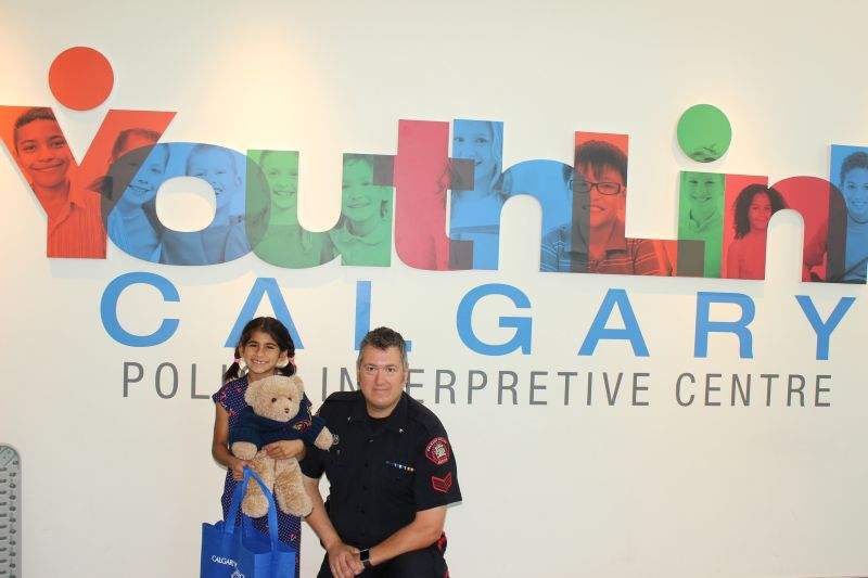 Ashlynn (left) and officer Dunn from the Calgary Police Service at CPS headquarters.