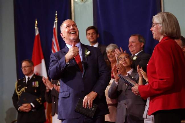 Premier John Horgan gives a thumbs up after giving an oath with Lieutenant-Governor Judith Guichon as he’s sworn-in as Premier during a ceremony with his provincial cabinet at Government House in Victoria, B.C., on Tuesday, July 18, 2017.