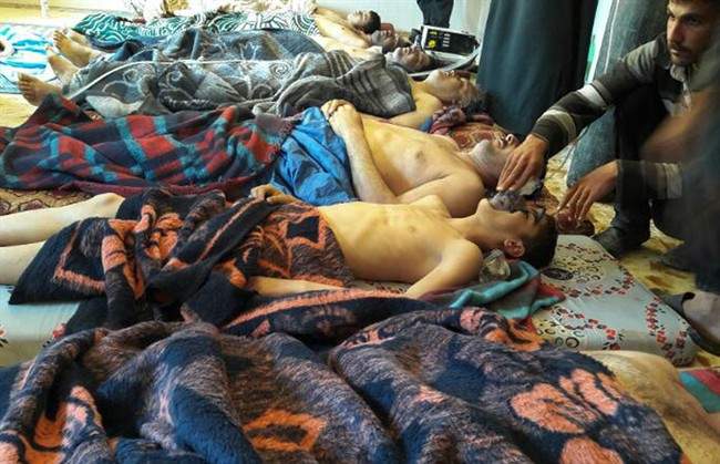 In this April 4, 2017 file photo, victims of a suspected chemical weapons attack lie on the ground in Khan Sheikhoun in the northern province of Idlib, Syria.