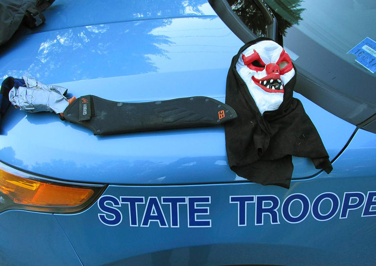 This Tuesday, July 25, 2017, photo released by the Maine State Police shows a clown mask and a machete that police said had been worn by Corey Berry, of Hollis, Maine. 