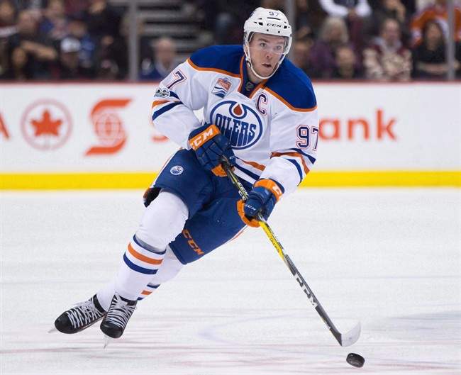 Edmonton Oilers' Connor McDavid skates with the puck during first period NHL hockey action against the Vancouver Canucks, in Vancouver, B.C., on Saturday, April 8, 2017. 