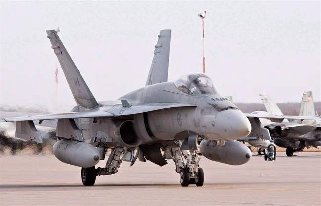 A pilot positions a CF-18 Hornet at the CFB Cold Lake, in Cold Lake, Alberta on Tuesday, October 21, 2014.