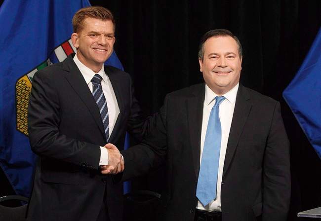 Alberta Wildrose leader Brian Jean and Alberta PC leader Jason Kenney shake hands after announcing a unity deal between the two in Edmonton on May 18, 2017.