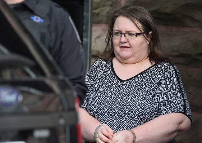 Elizabeth Wettlaufer is escorted by police from the courthouse in Woodstock, Ont, Monday, June 26, 2017.