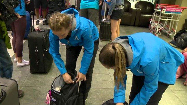 Martine and Margo Erlam checking their luggage at YYC Calgary International Airport.