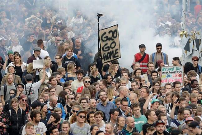 Demonstrators hold a sign 'G20 go home' during a dancing protest against the G-20 summit in Hamburg, northern Germany.