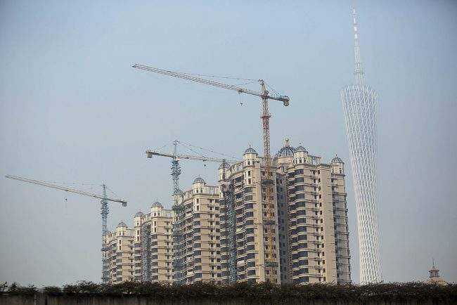 Cranes operate at a residential construction development in Guangzhou, China, Nov. 23, 2013.