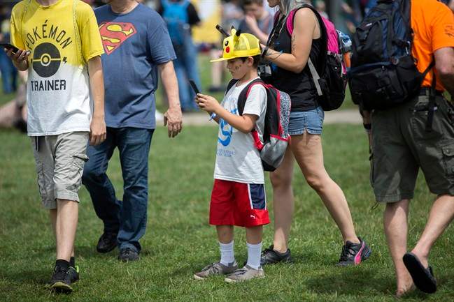 Landon Robles, 8, wears a Pikachu hat at the Pokemon Go Fest Saturday in Chicago. Many festival attendees had trouble getting the augmented-reality cellphone game to work.