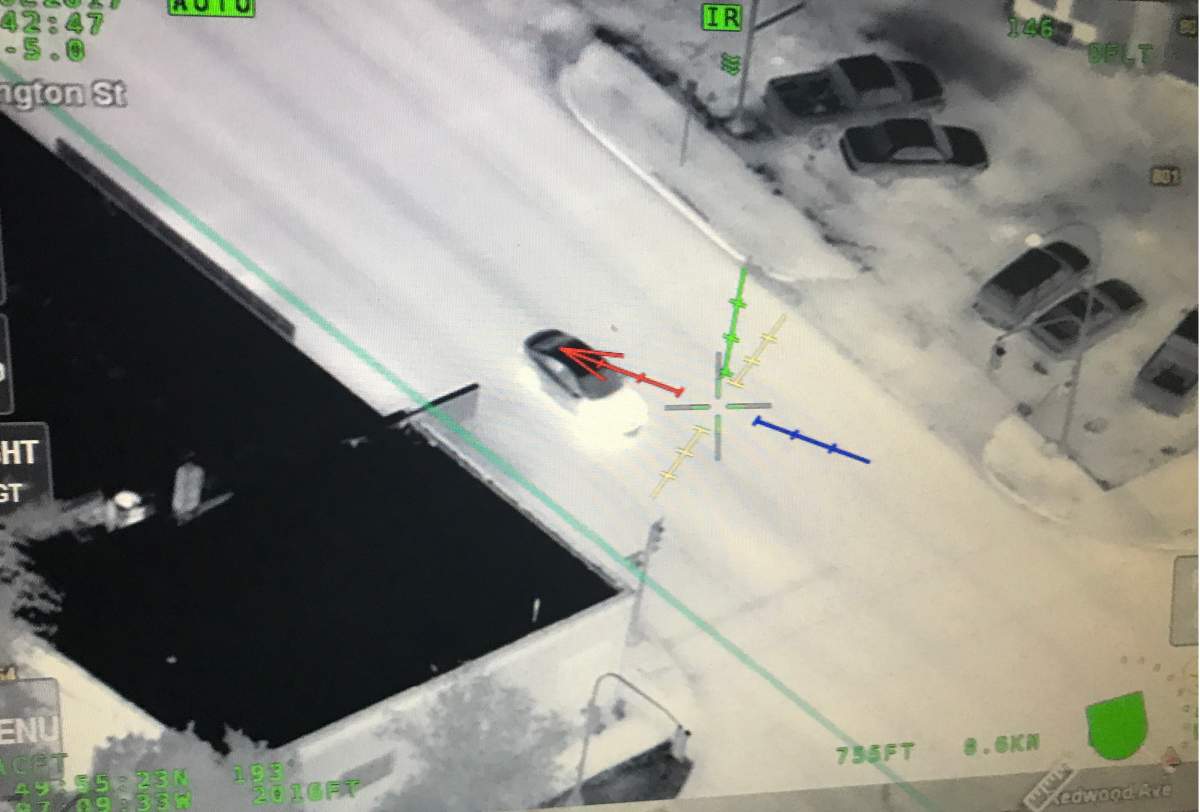 The infrared camera picks up heat signatures from hoods and tires of cars.