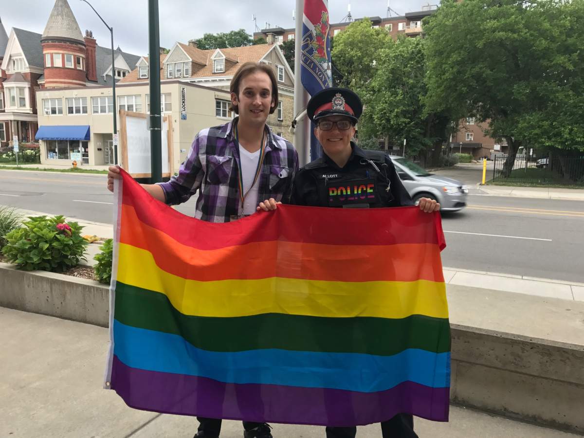 Pride London President Andrew Rosser and London Police Diversity Officer Theresa Allott raising the pride flag at police headquarters in London, Ont.